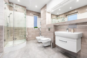 spacious and remodeled bathroom with glass doors