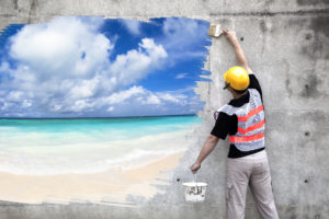 a commercial painter painting the interior wall of a commercial space with a metaphorical view of a beach