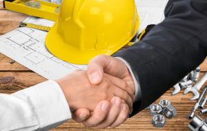 two commercial contractors shaking hands 