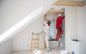 two home contractors doing home remodeling in a bedroom