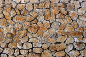 close up image of a rock wall with tan rocks