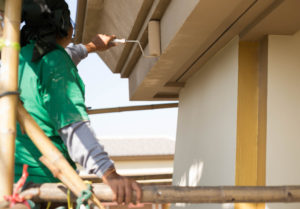 commercial painter painting a house