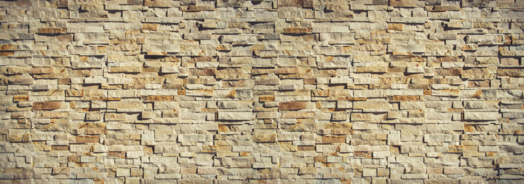 a close-up of a rock wall construction 